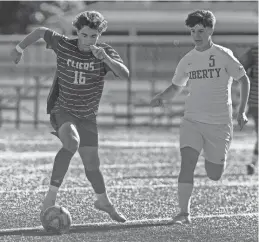  ?? ?? Jackson Liberty’s Dylan Kasnowski, right, seen defending Neptune’s Nate Kerr, had two goals when the Lions defeated Neptune 4-0 in Neptune on Thursday to improve to 2-0 in Group 1 in Shore Conference Tournament pool play.