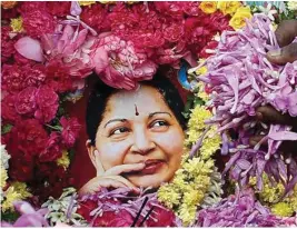  ??  ?? Supporters paying tribute to AIADMK leader J Jayalalith­aa in Madurai on Tuesday