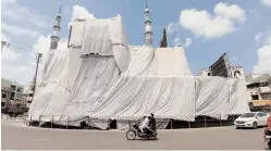  ?? — DC ?? Siddiamber Bazaar Mosque is covered on Saturday as a precaution­ary measure for Ganesh immersion.