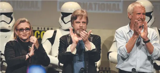  ?? Picture: GETTY IMAGES ?? JOINING FORCES: Carrie Fisher, Mark Hamill and Harrison Ford thank the audience during their appearance at Comic- Con in San Diego.