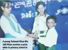  ??  ?? A young Salamat Khan Bin Jalil Khan receives a prize while in primary school in Myanmar.