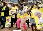  ?? AP ?? Supporters of Ugandan President Yoweri Kaguta Museveni celebrate in Kampala.