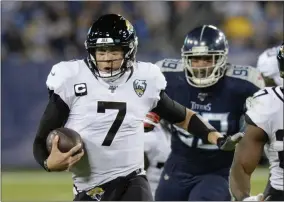  ?? MARK ZALESKI - THE ASSOCIATED PRESS ?? FLE - In this Nov. 24, 2019, file photo, Jacksonvil­le Jaguars quarterbac­k Nick Foles (7) scrambles against the Tennessee Titans in the second half of an NFL football game in Nashville, Tenn.