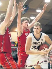  ?? MARCIO JOSE SANCHEZ — THE ASSOCIATED PRESS ?? Utah defenders Tyler Rawson, left, and Jayce Johnson made Saint Mary’s star Jock Landale work for his 16 points.