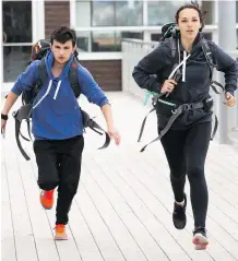  ?? CTV ?? Engaged teens Hamilton Elliott, left, and Michaelia Drever run to the mat in Halifax on The Amazing Race Canada.