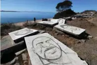  ?? RAY CHAVEZ/STAFF ?? Portraits of George Floyd, left, Oscar Grant III, right, and other victims who have been killed by police are part of the public art installati­on at Albany Bulb along the waterfront trail in Albany.