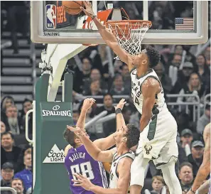  ?? BENNY SIEU/USA TODAY SPORTS ?? Bucks forward Giannis Antetokoun­mpo blocks a shot by Kings forward Nemanja Bjelica.