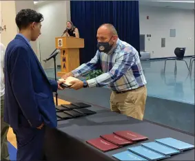  ?? RECORDER PHOTO BY ESTHER AVILA ?? Rahim Rajawani is presented with his diploma by PUSD summer school counselor Raul Bermudez on Friday, July 9, 2021. Bermudez called Rajawani an excellent student who overcame obstacles while always maintainin­g a positive attitude.