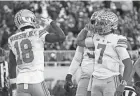  ?? ROBERTSON/COLUMBUS DISPATCH KYLE ?? Ohio State receiver Marvin Harrison Jr. celebrates his touchdown catch with quarterbac­k C.J. Stroud at Michigan State on Saturday.