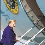  ?? Patrick Semansky Associated Press ?? PRESIDENT TRUMP boards Air Force One in Palm Beach, Fla., before departing for the White House, skipping his annual New Year’s Eve bash.