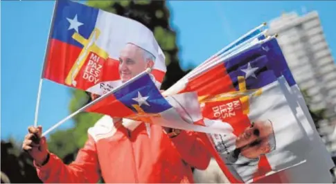  ?? REUTERS ?? Un hombre vende banderas con la imagen del Papa en el exterior de la catedral de San José de Temuco (Chile)