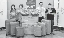  ??  ?? Society president Kelly Ho (second left) and Crown Square management representa­tive Tay Kien Hong (second right) with two other Loving Society members and some of the lucky draw prizes.