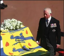  ??  ?? Charles, Prince of Wales walks behind the Duke of Edinburgh's coffin, covered with Philip's personal standard, during the ceremonial procession