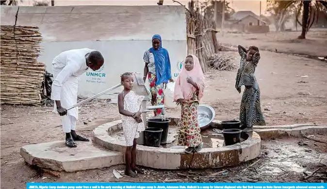  ?? —AFP ?? JIMETA, Nigeria: Camp dwellers pump water from a well in the early morning at Malkohi refugee camp in Jimeta, Adamawa State. Malkohi is a camp for internal displaced who fled their homes as Boko Haram insurgents advanced across northeaste­rn Nigeria.