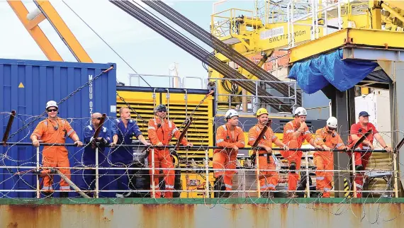  ?? AP ?? The staff of a vessel in charge of unloading oil from the decaying ship FSO Safer are pictured off the coast of Ras Issa, Yemen, on Tuesday, prior to the start of the unloading operation led by the UN to avoid an oil spill in the Red Sea.