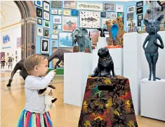  ??  ?? Menagerie: the central hall plays host to amateur animal paintings and sculpted dogs