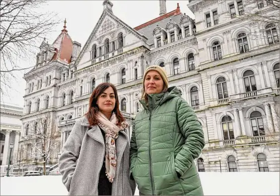  ?? Will Waldron / Times Union ?? Capital Region doulas, Liz Addeo, left, and Christine Hernandez, stand outside the Capitol in Albany. Legislator­s want an expansion of Medicaid to include doulas, birth coaches who provide physical, emotional and informatio­nal support to women during and immediatel­y after pregnancy.