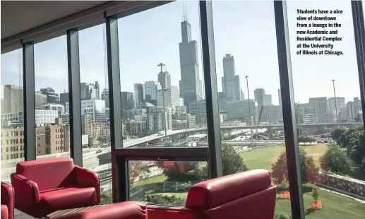 ??  ?? Students have a nice view of downtown from a lounge in the new Academic and Residentia­l Complex at the University of Illinois at Chicago.