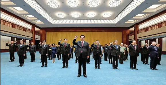  ?? LI XUEREN / XINHUA ?? President Xi Jinping, who is also general secretary of the Communist Party of China Central Committee and chairman of the Central Military Commission, leads senior Party officials in repeating their oath of joining the Party after inspecting an exhibition that displays the Party’s history in Beijing on Friday.