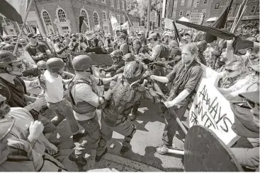  ?? Chip Somodevill­a photos / Getty Images ?? White nationalis­ts, neo-Nazis and members of the “alt-right” clash with counterpro­testers as they enter Lee Park during the “Unite the Right” rally on Saturday in Charlottes­ville, Va.