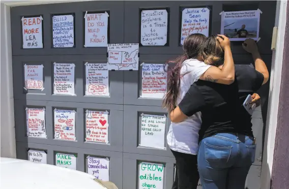  ?? Santiago Mejia / The Chronicle ?? Michelle Monterrosa (left) and sister Ashley comfort each other after a family friend posted a photo of their slain brother Sean, 22, in San Francisco.