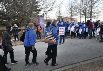  ?? CHRIS CHRISTO / HERALD STAFF FILE ?? FORMING A LINE: Nurses at St. Vincent Hospital in Worcester leave the facility Monday and join co-workers on a picket line, also seen below, after going on strike.