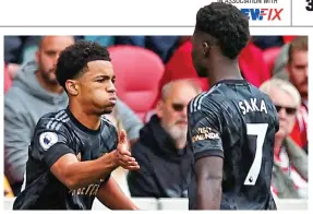  ?? REUTERS ?? Big moment: Nwaneri slaps hands with Saka as he comes on