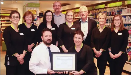  ??  ?? Staff at, Lloyds pharmacy Lower Main Street, Gorey receive the Gorey Chamber, Ulster Bank outstandin­g customer care and service award. Front – Ulster bank customer advisor, David Proby presents the award to manager, Marie Noctor. Back – staff members,...