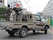  ?? Saleh Al-Obeidi / AFP/Getty Images ?? Yemeni loyalist fighters patrol the streets of central Aden. Forces hostile to Houthi rebels have sent reinforcem­ents to the port of Hodeida.