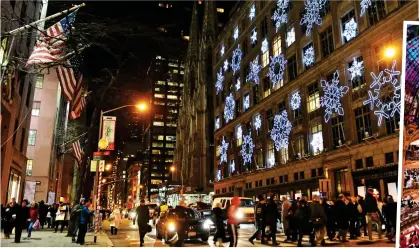  ?? ?? FESTIVE FAVOURITE: New York’s Fifth Avenue, above. Right: Paris’s marble-clad Galeries Lafayette