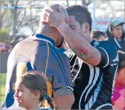  ??  ?? Graceful in defeat: Pacific’s Shane Tekuru embraces a member of the winning Pikiao team.