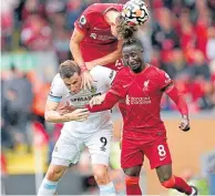  ??  ?? Liverpool’s Kostas Tsimikas clears