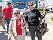  ?? DAVID SANTIAGO dsantiago@miamiheral­d.com ?? Maria Rosa Benitez, 94, and Mariana Reyes, 67, leave after voting at Surfside Town Hall on Tuesday. Donald Trump received around 86% of Miami-Dade’s GOP vote.