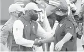  ?? CHRIS O’MEARA/ AP ?? Patriots coach Bill Belichick, right, greets Dolphins coach Brian Flores at the end of a game on Dec. 20, 2020, in Miami Gardens.