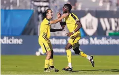  ??  ?? United’s Saalih Muhammad (right) celebrates his first-half goal with midfielder Juan Guzman.
