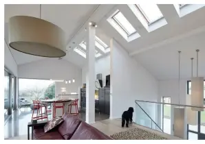  ??  ?? A row of rooflights throws light down into the open-plan kitchen-living-dining area