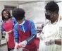  ?? (Special to The Commercial/University of Arkansas at Pine Bluff) ?? Participan­ts and instructor­s shred cabbage and mix ingredient­s. They include Danyell Hughes (from left) Tony Bradly and Desheryl Alexander.