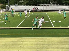  ?? (The Sentinel-Record/ Braden Sarver) ?? Hot Springs junior Kevin Dubon tries to keep the ball away from a Van Buren defender on Thursday during the first round of the Class 5A state tournament.