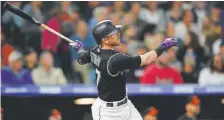  ?? David Zalubowski, The Associated Press ?? Trevor Story follows the flight of his 100th career home run in the seventh inning Friday.
