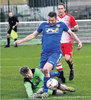  ??  ?? Skem’s Richard Brodie is tripped by Whitchurch Alport keeper Jack Atkinson to earn United a penalty