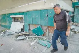  ?? AP PHOTO/EFREM LUKATSKY ?? A local resident passes by shrapnel traces Monday following Russian night shelling in the town of Bakhmut, Donetsk region, Ukraine.