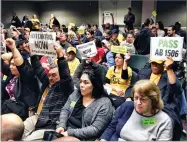  ?? AP PHOTO BY KATHLEEN RONAYNE ?? Voters hold signs demonstrat­ing their support for legislatio­n that would allow California communitie­s to expand rent control policies during a legislativ­e hearing in Sacramento on Thursday.