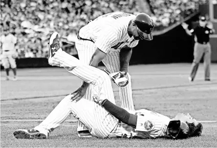  ?? BRAD PENNER, USA TODAY SPORTS ?? Mets second baseman Neil Walker, being tended to by first-base coach Tom Goodwin, is among the latest round of New York players to go on the disabled list.