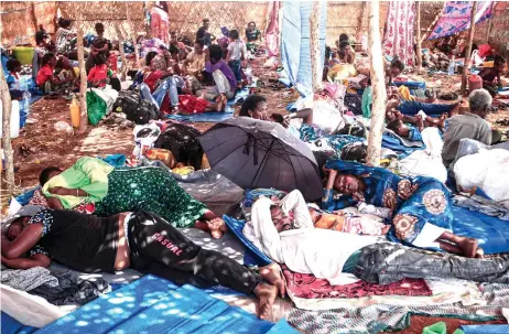  ?? — AFP photo ?? Ethiopian refugees who fled fighting in Tigray province lay in a hut at the Um Rakuba camp in Sudan’s eastern Gedaref province. The United Nations said Tuesday that thousands of people were fleeing Ethiopia’s conflict-torn northern Tigray region and the border area with Sudan now faced a profound humanitari­an emergency.