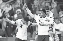  ?? JULIO CORTEZ/AP ?? United States’ Weston McKennie (8) celebrates his goal against Mexico with Tyler Adams, left, and Christian Pulisic on Nov. 12.