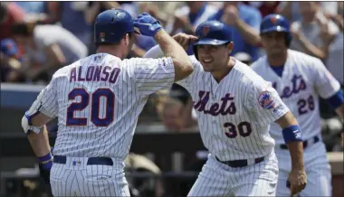  ?? MARK LENNIHAN ?? New York Mets’ Pete Alonso, left, is met at home plate by teammate Michael Conforto after hitting a two-run home run against the Miami Marlins in the first inning of a baseball game, Wednesday, Aug. 7, 2019, in NewYork.