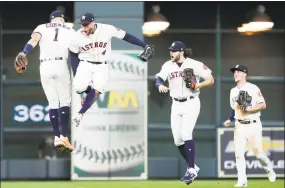  ?? Associated Press ?? From left, Astros shortstop Carlos Correa, outfielder George Springer, outfielder Jake Marisnick and Myles Straw celebrate Saturday’s win.