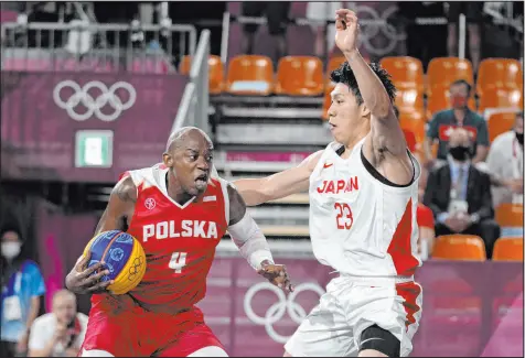  ?? Jeff Roberson The Associated Press ?? Poland’s Michael Hicks tries to drive against Japan’s Ryuto Yasuoka in a men’s 3-on-3 game won by Poland 20-19.