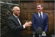  ?? AP PHOTO BY RICH PEDRONCELL­I ?? Governor-elect Gavin Newsom, right, smiles as Gov. Jerry Brown responds to a reporter's question after meeting at the Capitol, Tuesday, Nov. 13, in Sacramento, Calif.