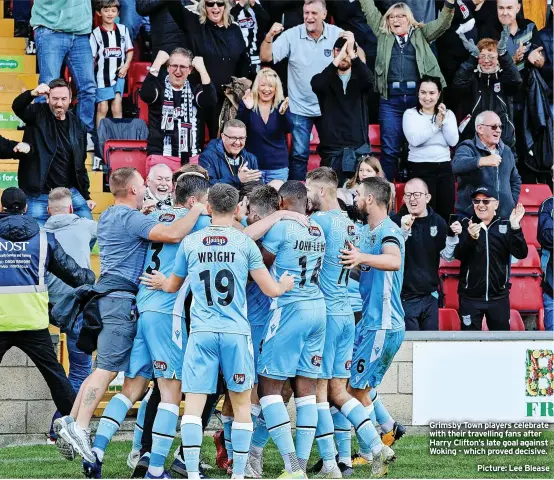  ?? Picture: Lee Blease ?? Grimsby Town players celebrate with their travelling fans after Harry Clifton’s late goal against Woking - which proved decisive.